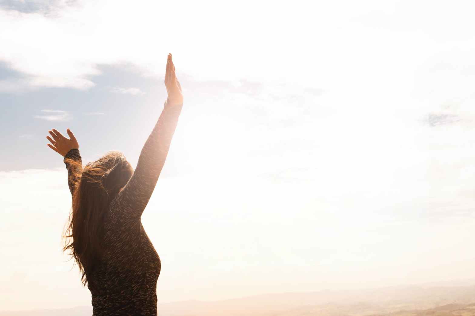 photo of woman raising both hands